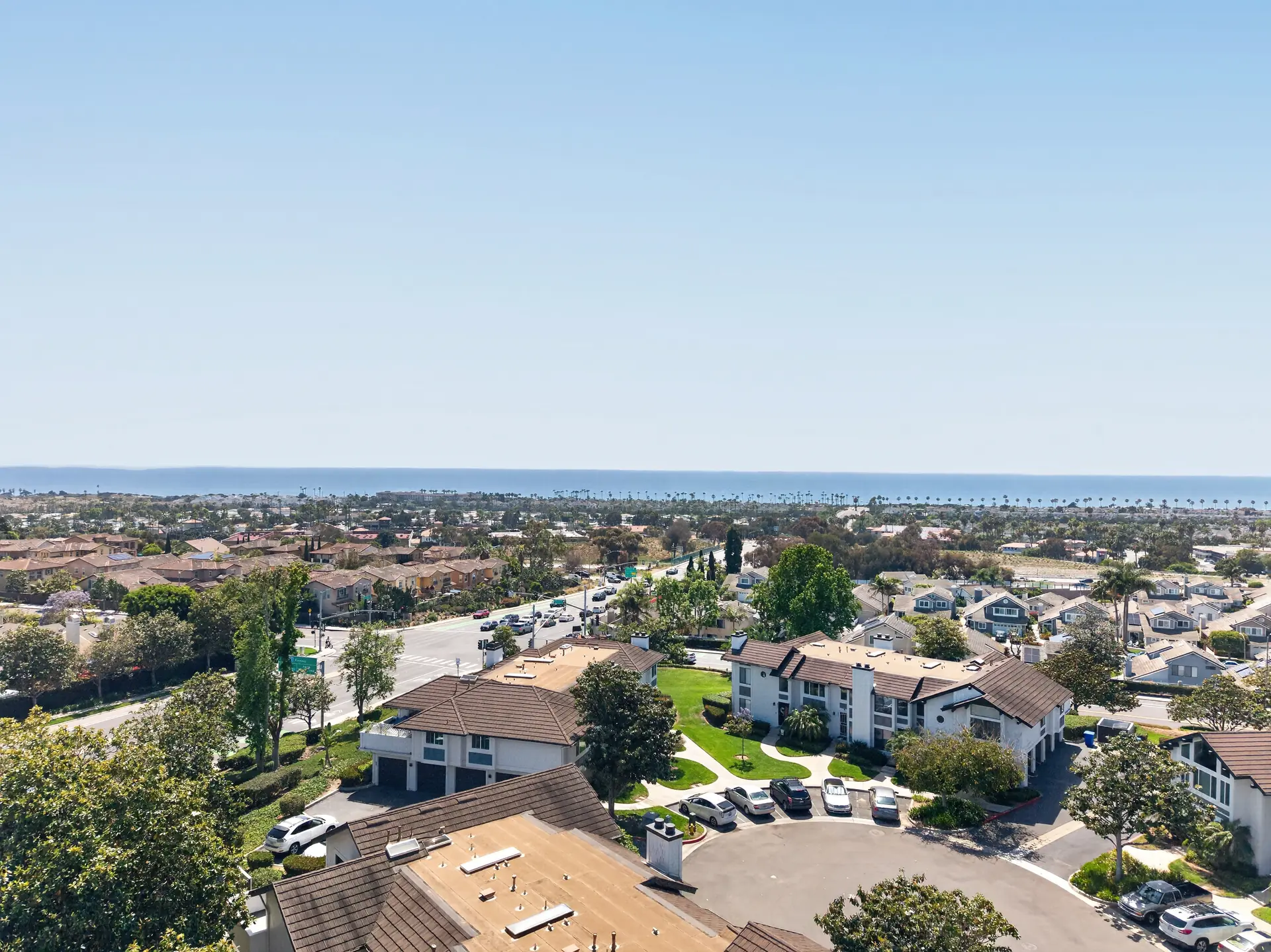 Aerial drone photo of coastal Orange County neighborhood with Pacific Ocean on horizon
