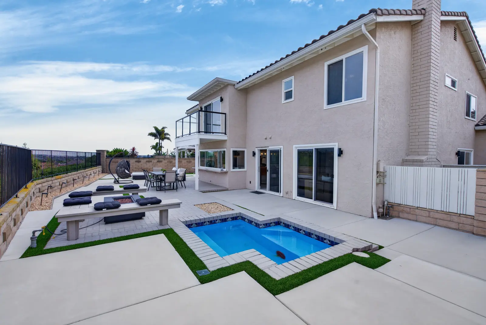Ground backyard with pool, patio, and seating area